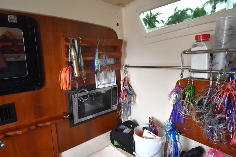 Slide: The Image of Interior of a 2010 Grady-White Canyon 366 boat with fishing lures and equipment. - 25
