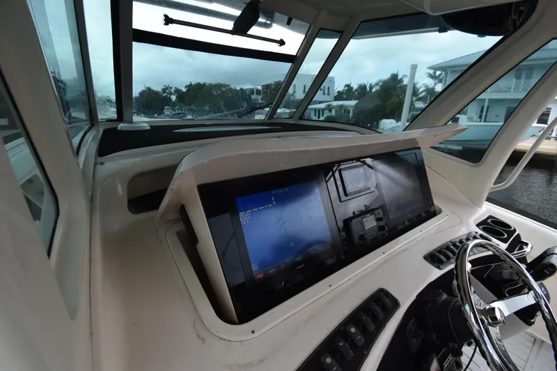 Slide: The Image of 2010 Grady-White Canyon 366 helm with navigation screens and steering wheel. - 4