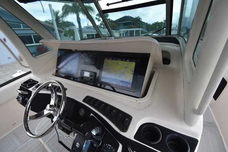 Slide: The Image of Helm of 2010 Grady-White Canyon 366 with navigation display and steering wheel. - 5