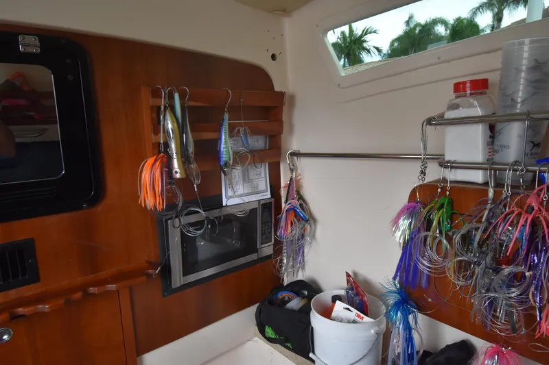 Slide: The Image of Interior of a 2010 Grady-White Canyon 366 boat with fishing lures and equipment. - 8