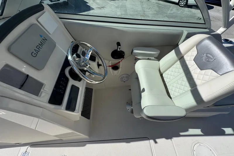Slide: The Image of Helm of 2023 Sailfish 245 DC boat with Garmin navigation system and cushioned captain's chair. - 10