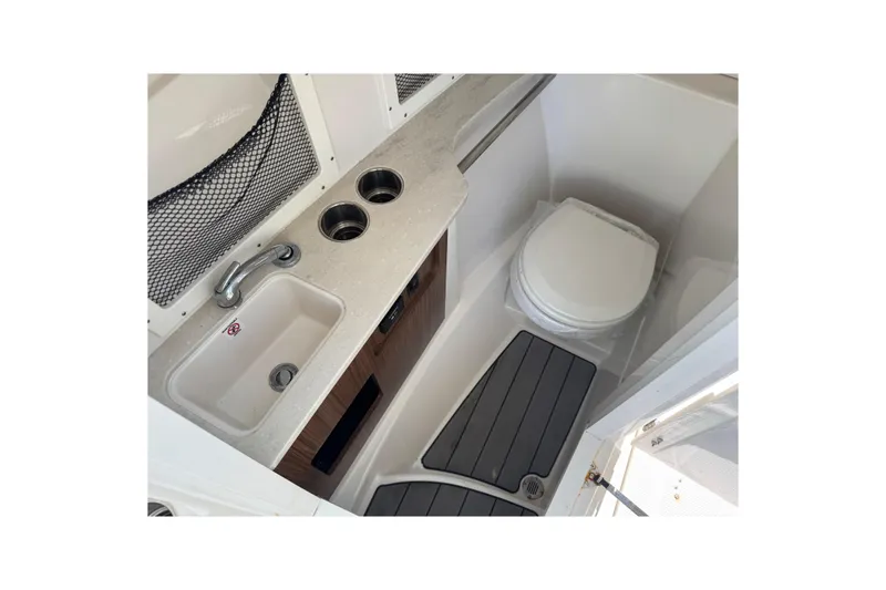 Slide: The Image of 2023 Sailfish 245 DC boat interior with sink and toilet. - 11