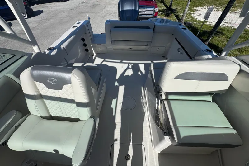 Slide: The Image of 2023 Sailfish 245 DC boat interior with cushioned seating and modern design. - 12