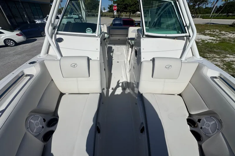 Slide: The Image of 2023 Sailfish 245 DC boat interior with white seating and cup holders. - 14