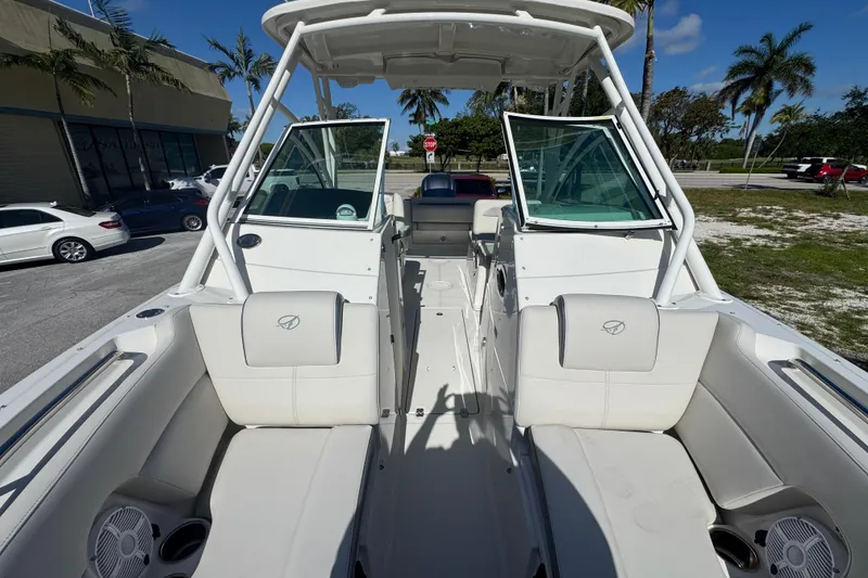Slide: The Image of 2023 Sailfish 245 DC boat interior with white seating and open deck layout. - 15