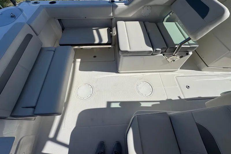Slide: The Image of Interior view of 2023 Sailfish 245 DC boat with cushioned seating. - 6