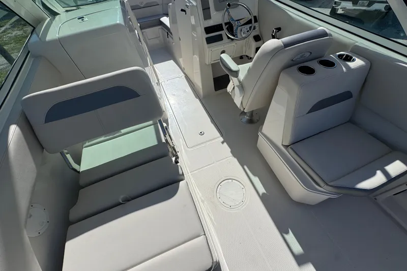 Slide: The Image of 2023 Sailfish 245 DC boat interior with seating and steering console. - 7