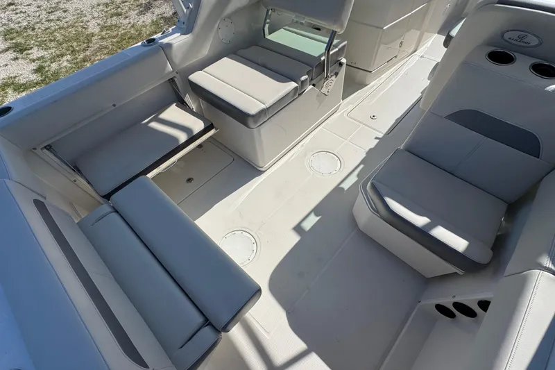 Slide: The Image of Interior seating of 2023 Sailfish 245 DC boat, featuring cushioned seats and cup holders. - 8