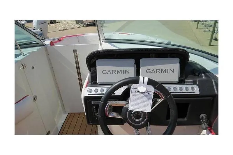 Slide: The Image of 2024 Crownline 250 XSS boat dashboard with dual Garmin displays. - 6