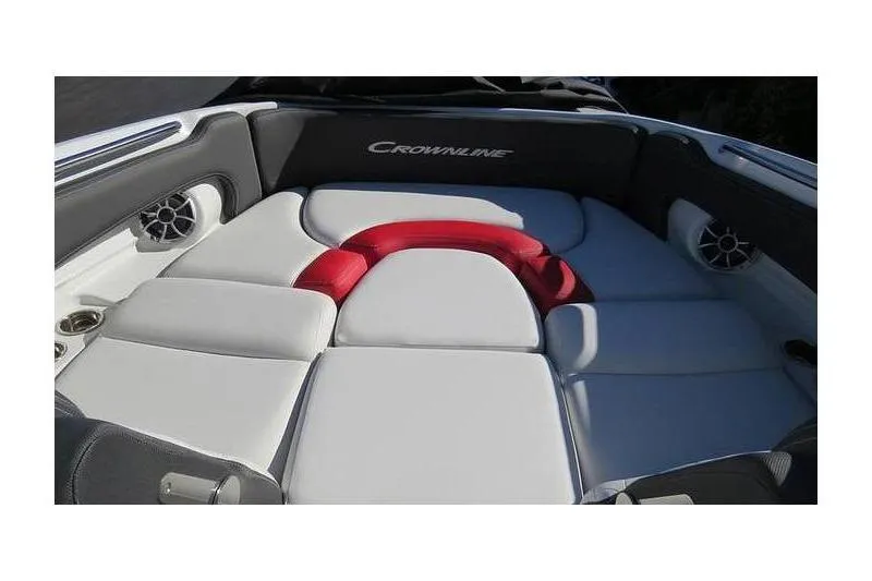 Slide: The Image of 2024 Crownline 250 XSS boat interior with cushioned seating and speakers. - 7