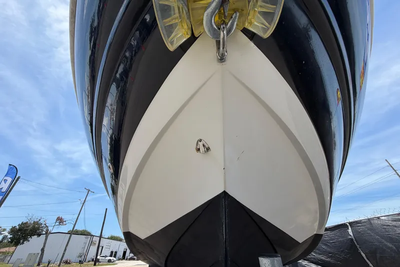 Slide: The Image of 2018 Stingray 204 LR boat hull, close-up view from below, against blue sky. - 10