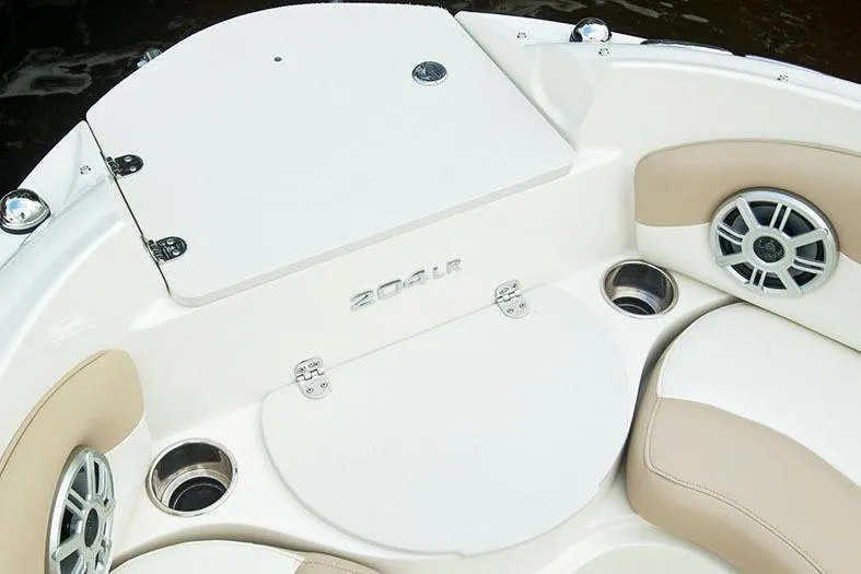 Slide: The Image of Manufacturer Provided Image: 2018 Stingray 204 LR boat interior with beige seating and cup holders. - 2