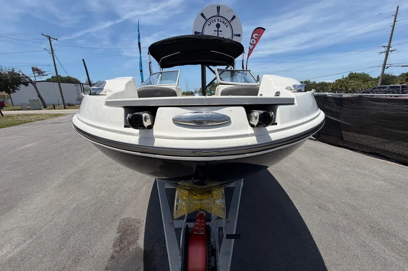 Slide: The Image of 2018 Stingray 204 LR boat on trailer under clear blue sky. - 8