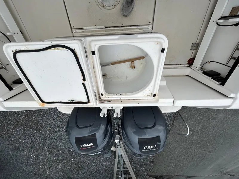 Slide: The Image of 1996 Robalo 2440 Walkaround boat with Yamaha outboard motors, open storage compartment. - 10