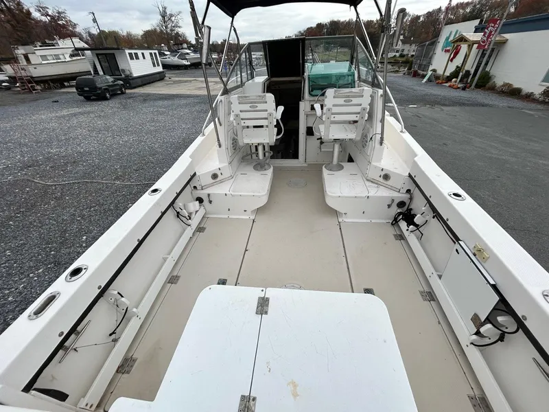 Slide: The Image of 1996 Robalo 2440 Walkaround boat interior with seating and storage compartments. - 7