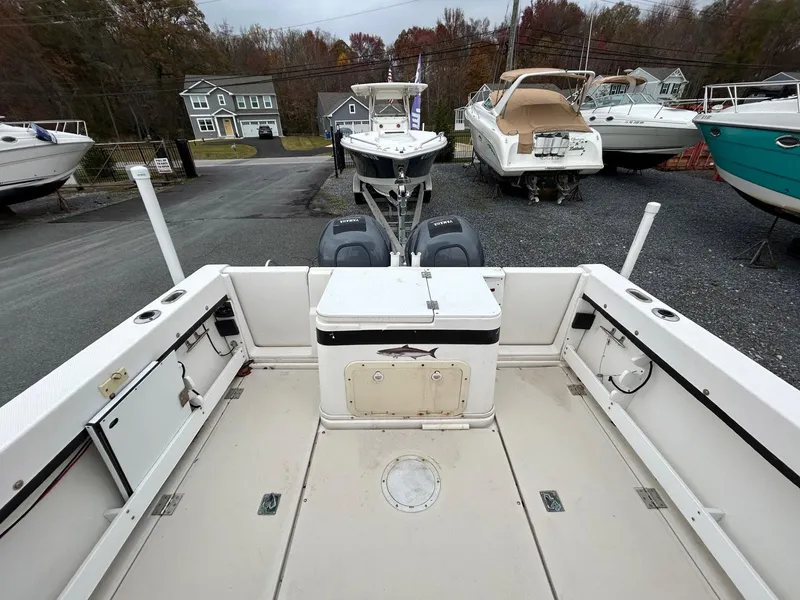 Slide: The Image of 1996 Robalo 2440 Walkaround boat interior, featuring spacious deck and storage compartments. - 9