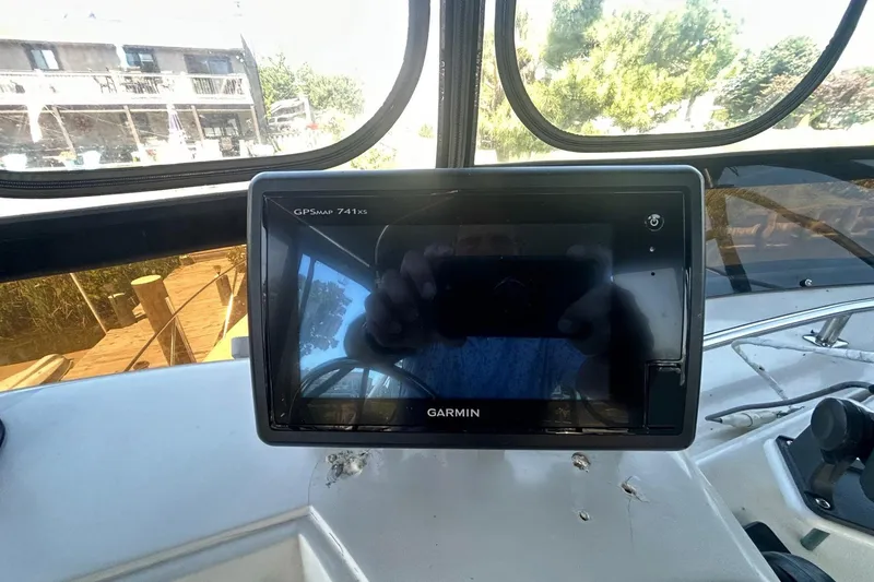 Slide: The Image of 1990 Silverton 34 Convertible helm with Garmin GPSMAP 741xs navigation system. - 15