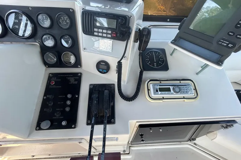 Slide: The Image of Control panel of a 1990 Silverton 34 Convertible boat with gauges and radio equipment. - 16