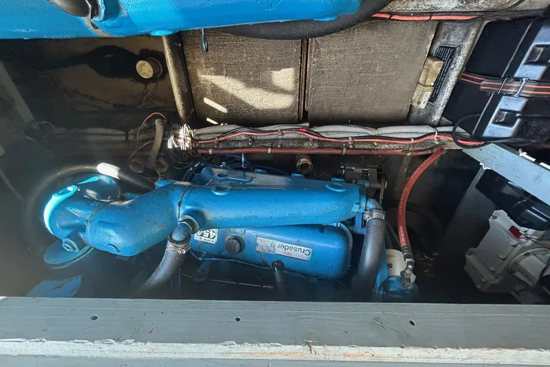 Slide: The Image of Engine compartment of a 1990 Silverton 34 Convertible boat, featuring a Crusader engine. - 30