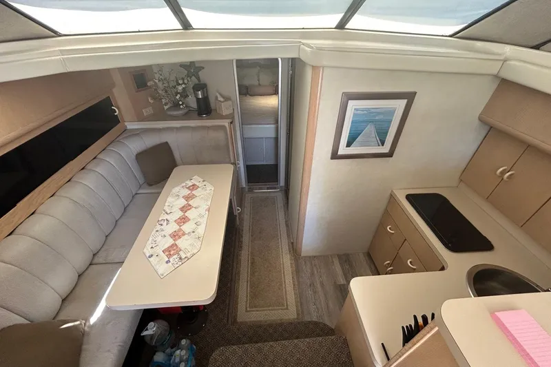Slide: The Image of Interior of 1990 Silverton 34 Convertible yacht with cozy seating and compact kitchen area. - 23
