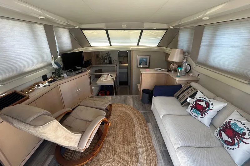 Slide: The Image of Interior of 1990 Silverton 34 Convertible yacht with cozy seating and decor. - 20