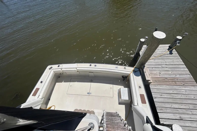 Slide: The Image of 1990 Silverton 34 Convertible boat docked at a wooden pier, viewed from above. - 19