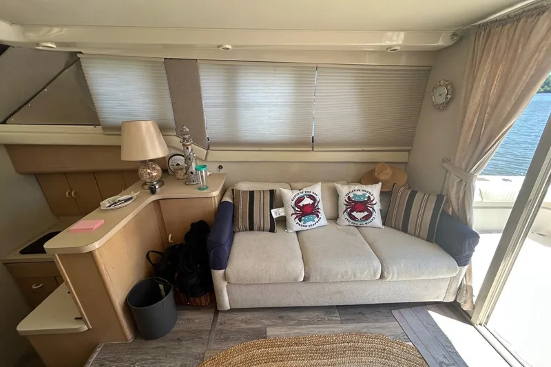 Slide: The Image of Interior of 1990 Silverton 34 Convertible yacht with cozy sofa and nautical decor. - 22