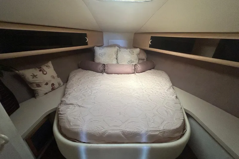 Slide: The Image of Cozy bedroom in 1990 Silverton 34 Convertible yacht with elegant bedding and storage. - 26