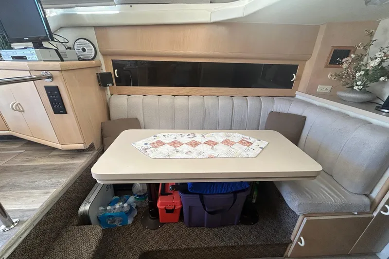 Slide: The Image of Interior of 1990 Silverton 34 Convertible with cozy dining area and table setting. - 25