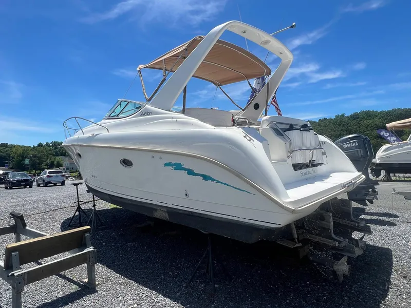 Slide: The Image of 1996 Silverton 310 Express boat on dry dock under clear blue sky. - 1