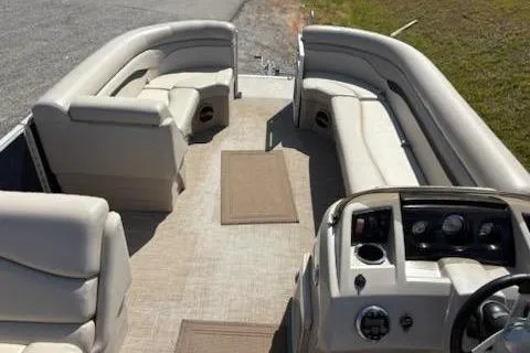 Slide: The Image of 2017 Bennington 22SLX pontoon boat interior with beige seating and dashboard. - 11