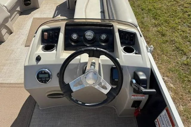Slide: The Image of 2017 Bennington 22SLX boat dashboard with steering wheel and control panel. - 13