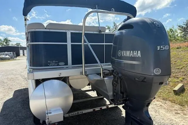 Slide: The Image of 2017 Bennington 22SLX pontoon boat with Yamaha 150 outboard motor, parked on trailer. - 6