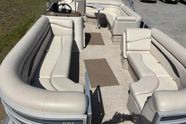 Slide: The Image of 2017 Bennington 22SLX pontoon boat with spacious seating and beige upholstery. - 7