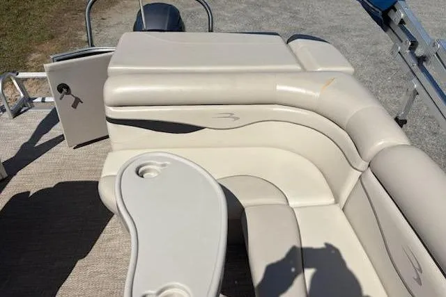 Slide: The Image of 2017 Bennington 22SLX boat interior with beige seating and cup holders. - 8