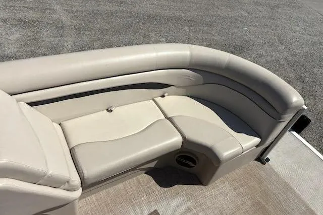 Slide: The Image of 2017 Bennington 22SLX pontoon boat with beige seating and carpeted deck. - 9