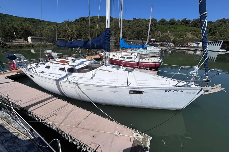 The Image of 1990 Beneteau Oceanis 350 sailboat docked in a serene marina setting. - 0