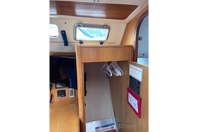 Slide: The Image of Interior of 1990 Beneteau Oceanis 350 sailboat with wooden cabinetry and porthole window. - 20