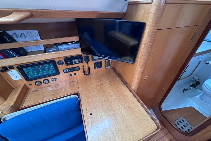 Slide: The Image of Interior of 1990 Beneteau Oceanis 350 sailboat with navigation equipment and TV. - 21