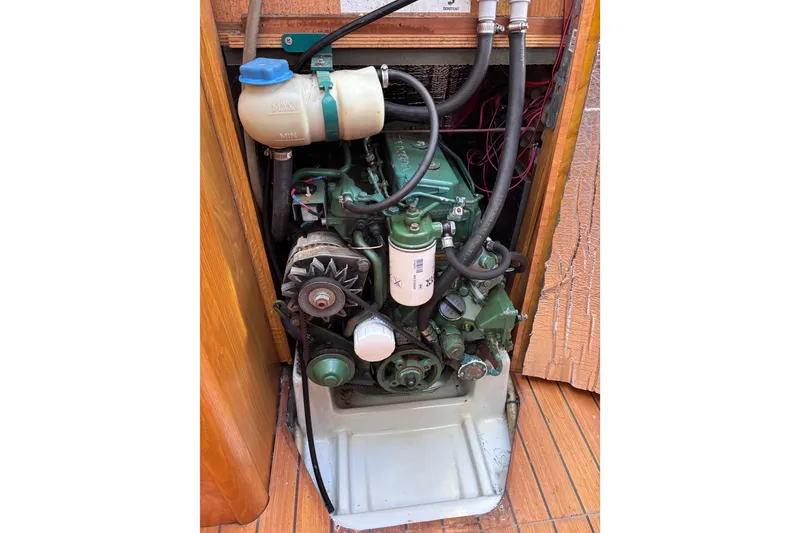 Slide: The Image of Engine compartment of a 1990 Beneteau Oceanis 350 sailboat, showcasing mechanical components. - 24
