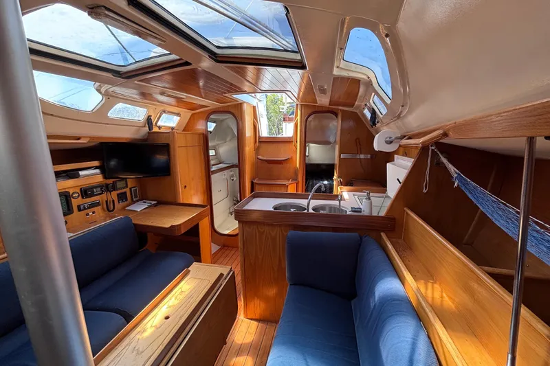 Slide: The Image of Interior of 1990 Beneteau Oceanis 350 sailboat with cozy seating and modern amenities. - 5