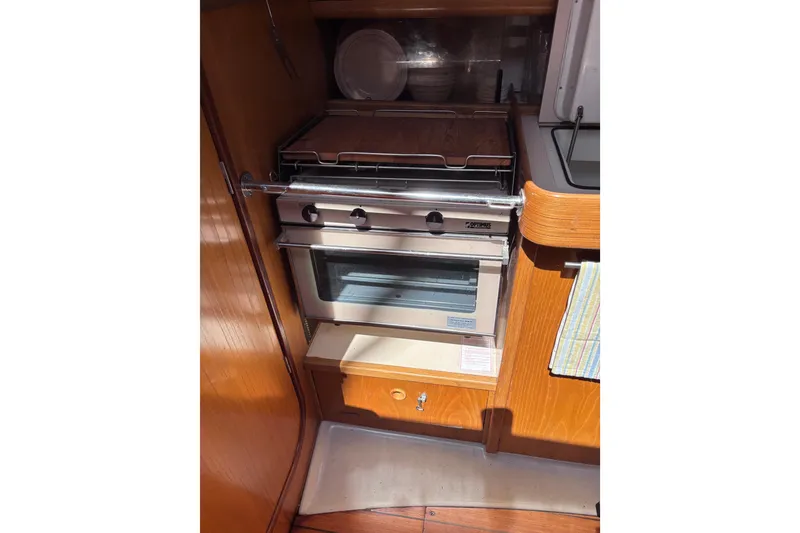 Slide: The Image of Galley kitchen in 1990 Beneteau Oceanis 350 sailboat with stove and oven. - 8