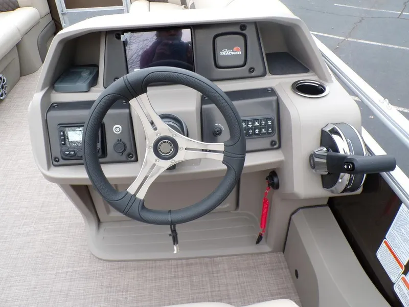 Slide: The Image of 2024 Sun Tracker SportFish™ 22 DLX boat dashboard with steering wheel and control panel. - 16