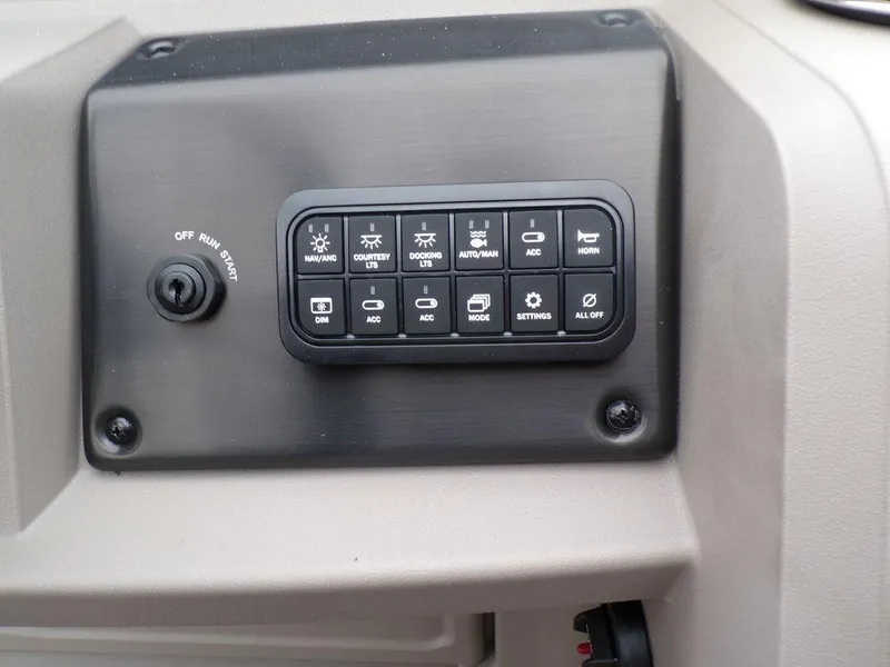 Slide: The Image of Control panel of 2024 Sun Tracker SportFish™ 22 DLX boat with various switches. - 17