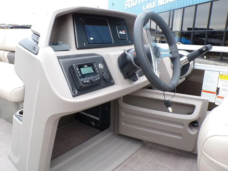 Slide: The Image of 2024 Sun Tracker SportFish™ 22 DLX boat dashboard and steering wheel. - 19