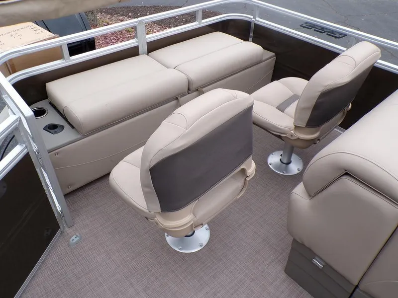 Slide: The Image of 2024 Sun Tracker SportFish™ 22 DLX interior with beige seating and cup holders. - 21