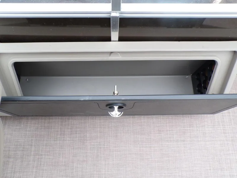 Slide: The Image of Open storage compartment on 2024 Sun Tracker SportFish™ 22 DLX pontoon boat. - 23