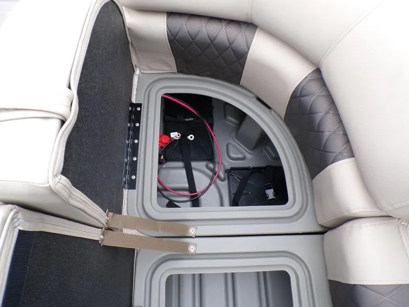 Slide: The Image of Sun Tracker SportFish™ 22 DLX 2024 under-seat storage compartment with battery and wiring. - 32