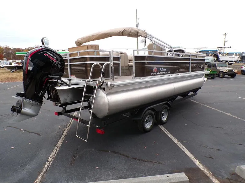 Slide: The Image of 2024 Sun Tracker SportFish™ 22 DLX pontoon boat on a trailer, rear view. - 5