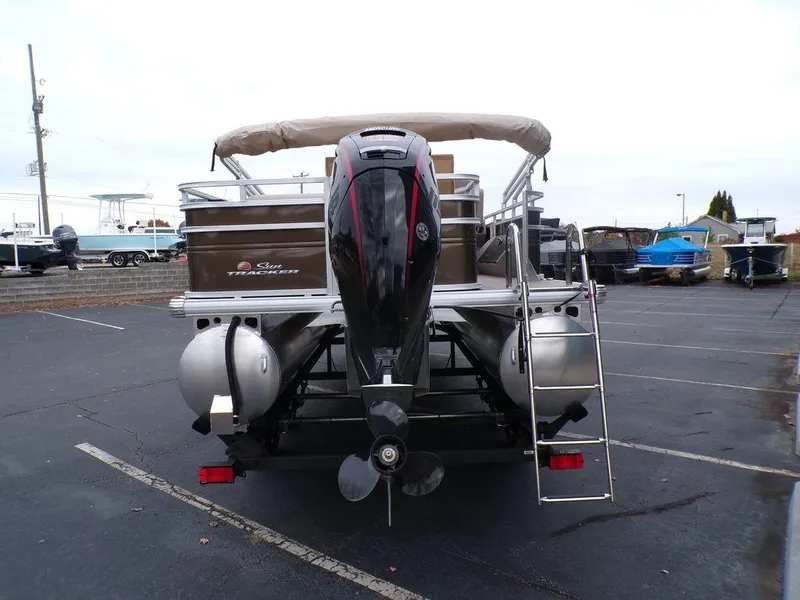 Slide: The Image of 2024 Sun Tracker SportFish™ 22 DLX pontoon boat rear view with outboard motor. - 6
